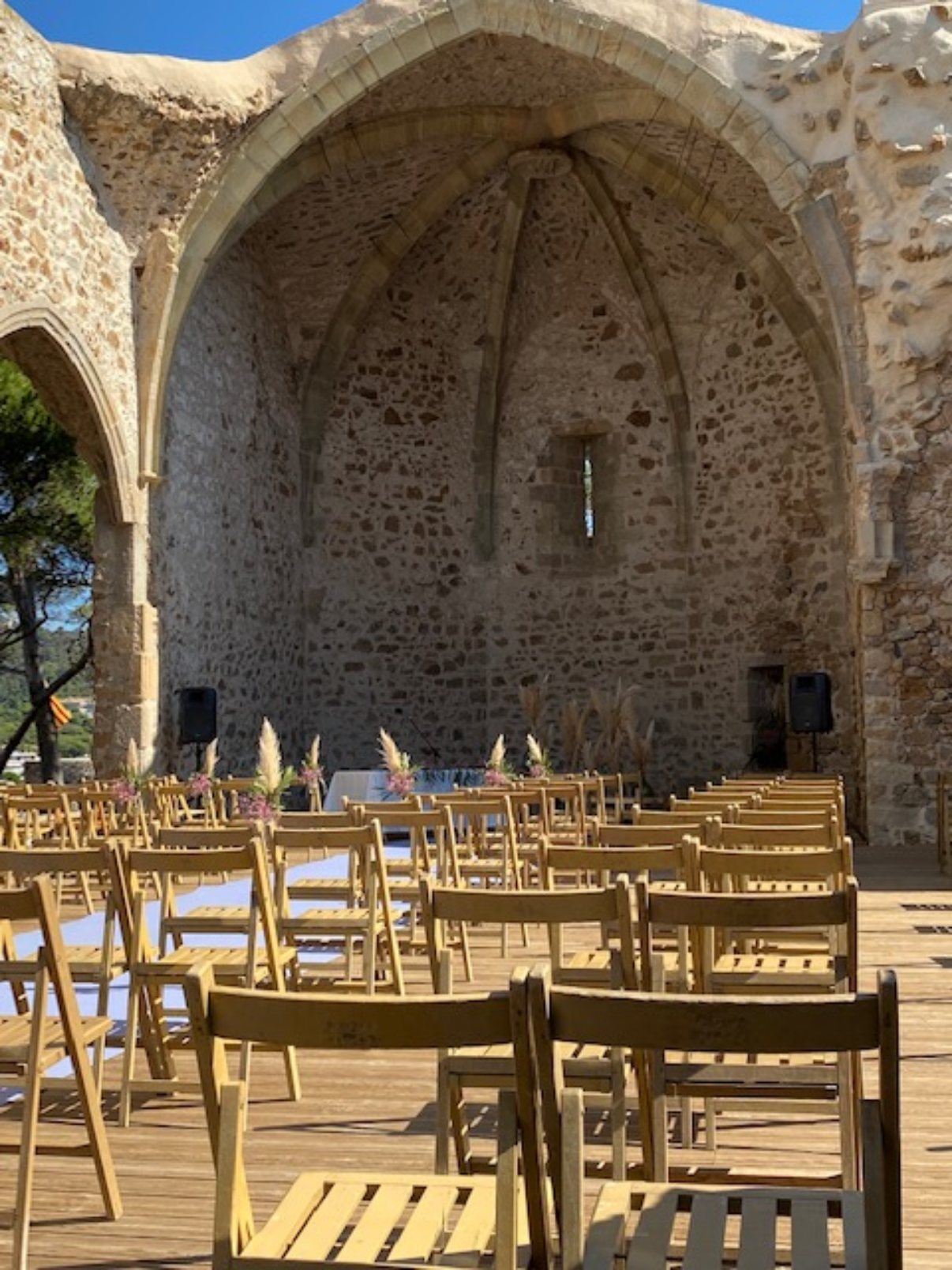 Inside the open-air Gothic apse, set with wooden chairs for a ceremony